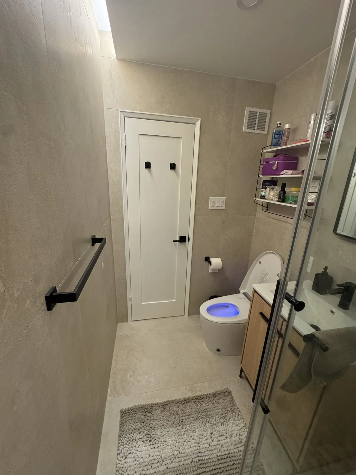 Finished bathroom looking toward the door, with the new walk-in glass shower