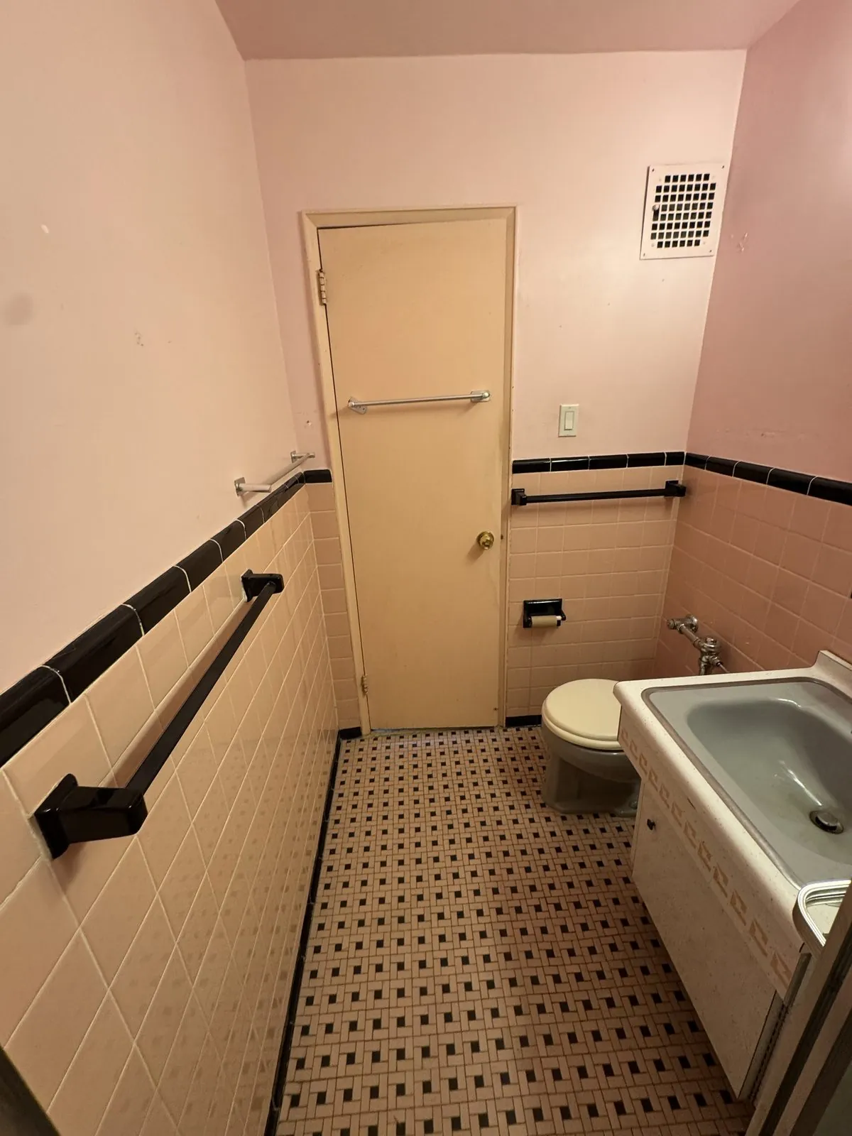 Original peach-tile bathroom, door and basket-weave tile floor