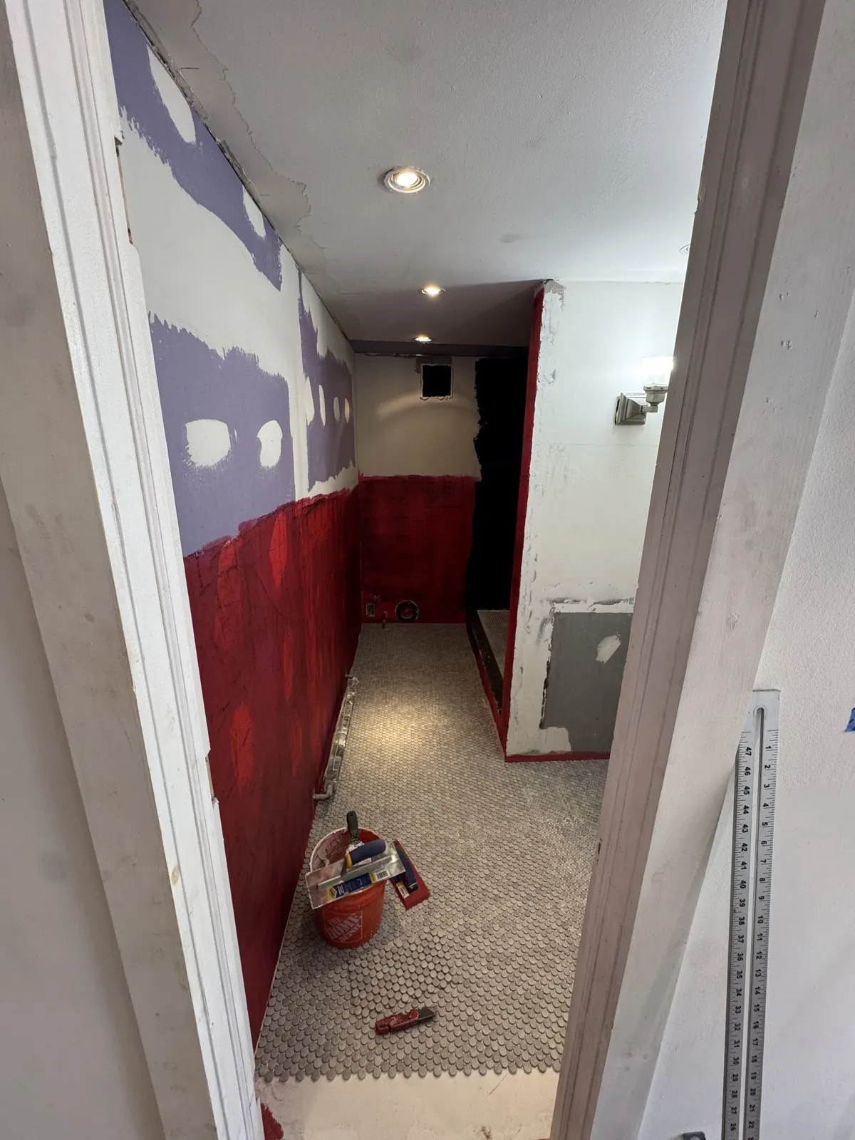 Red waterproofing applied and the mosaic floor going in