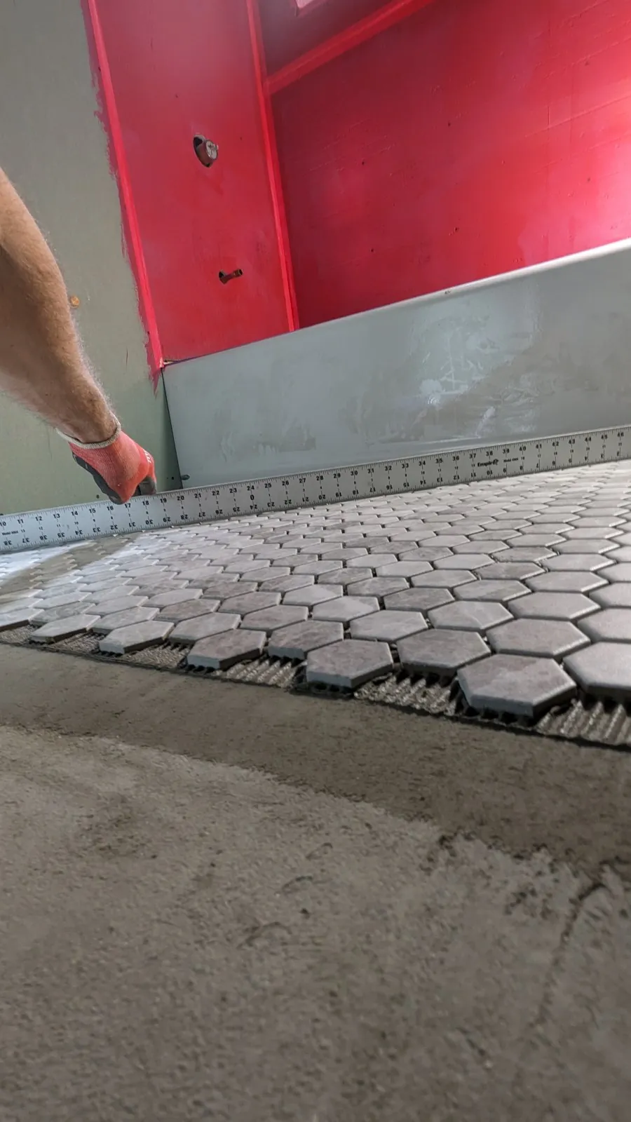 Gray marble hexagon mosaic floor being laid