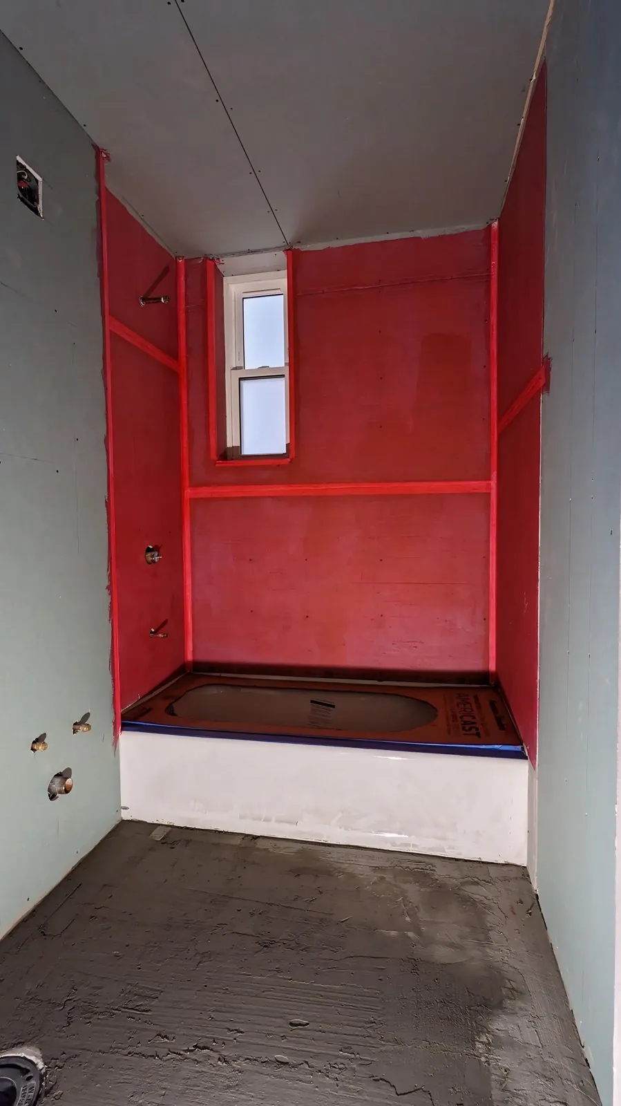 Red waterproofing membrane applied to the walls